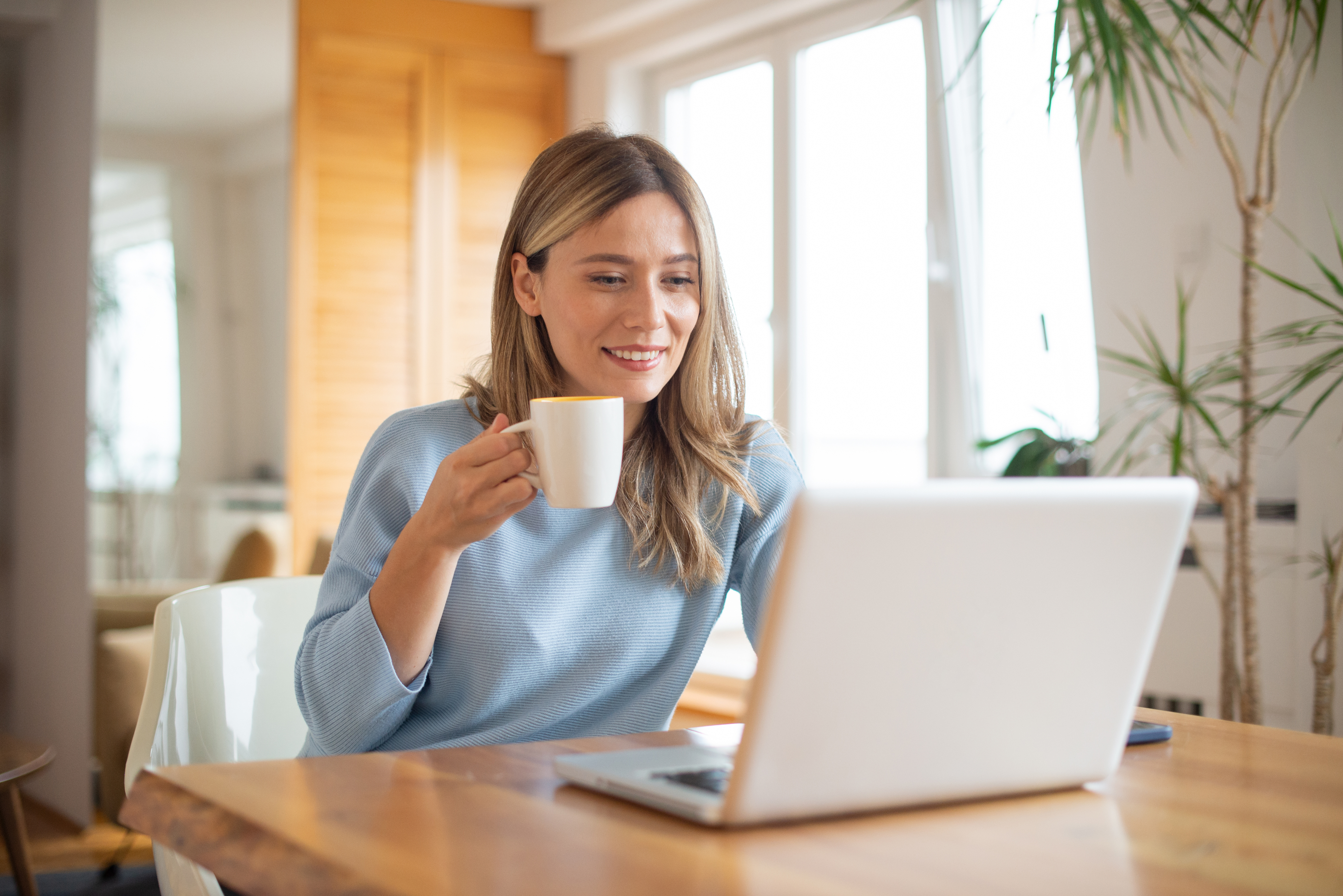 Professional working on a laptop during a virtual meeting